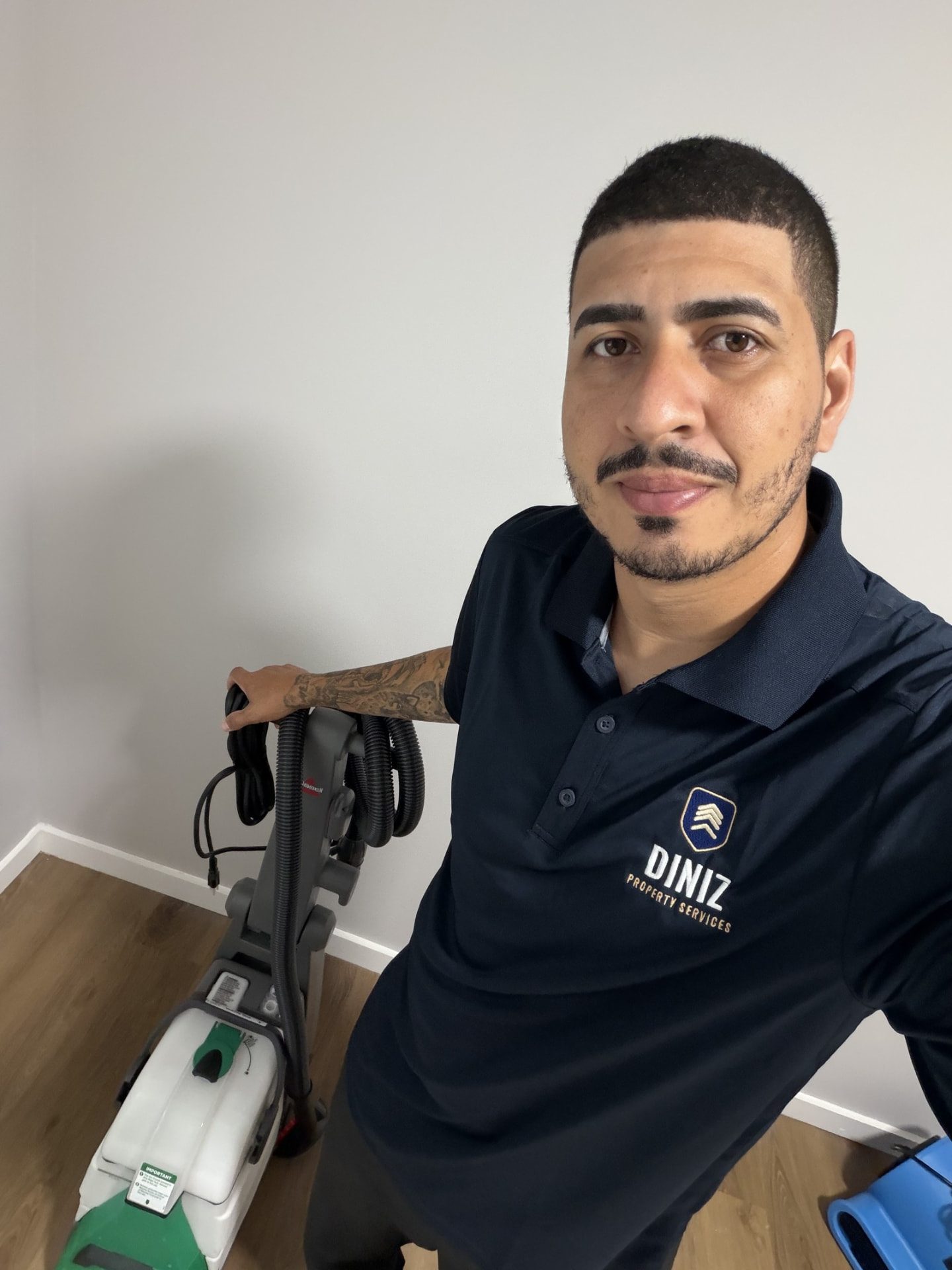 Igor Diniz in a Diniz Property Services uniform with a carpet cleaning machine on a job in Connecticut